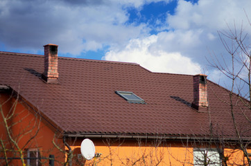 attic window and brick pipes on the roof.