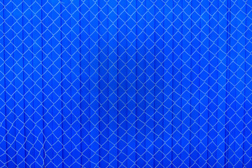 Fototapeta na wymiar Blue metal fence with steel mesh