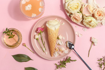 Light pink set of dishes on the table. Delicate rosebuds of pastel colors and petals on a plate and...