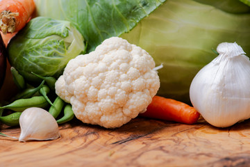 A variety of fresh raw Organic Vegetables including Cabbage, Garlic, Carrots, Cauliflowers.
