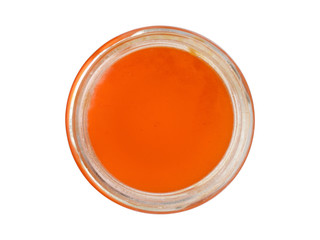 Glass jar with honey the top view isolated on a white background