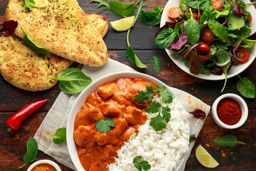 Chicken tikka masala curry with rice and naan bread