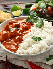 Chicken tikka masala curry with rice and naan bread