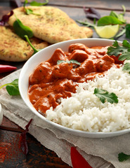 Chicken tikka masala curry with rice and naan bread