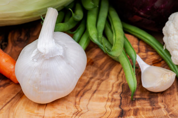 A variety of fresh raw Organic Vegetables including Cabbage, Garlic, Onion, Carrots, Cauliflowers.