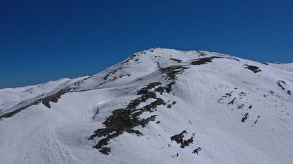 Aerial drone photo of popular winter ski destination in Swiss mountain covered up with snow