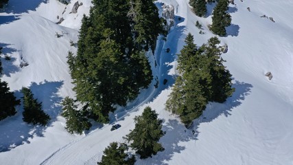 Aerial drone photo of iconic snowed mountain of Parnassus with popular ski resort covered up in snow and unique nature, Voiotia, Greece