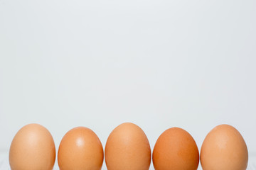 Close up of chicken eggs over white background