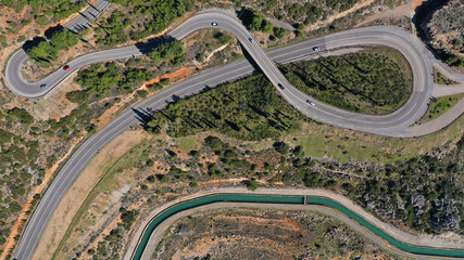 Aerial drone top view photo of snake curvy road built in steep mountain slope
