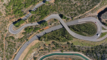 Aerial drone top view photo of snake curvy road built in steep mountain slope