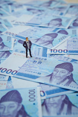 Korean won banknotes and miniature man