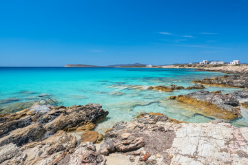 Fototapeta na wymiar Rocky beach with amazing tranquil water on Paros island, Cyclade