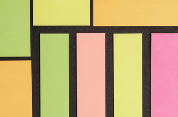 Blank note paper set of different colours forms and sizes. Sticky notes collection on black background
