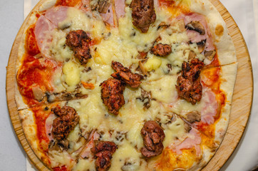 Delicious pizza with meat and cheese - close-up