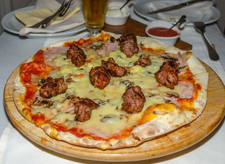 Served delicious pizza with meat and cheese
