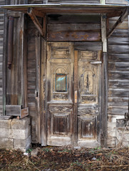 Old paneled wooden door with mail box in abandoned house, Russia