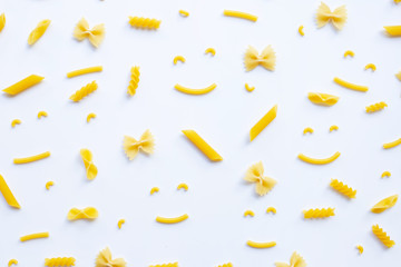 Different types of dry pasta on white.