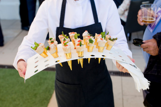 Waiter serving food in cocktail