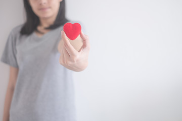 beautiful Asian woman show red heart isolated on a white background with copy space