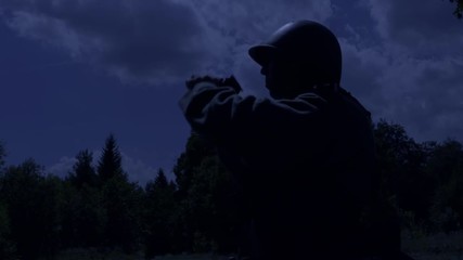 Soldier is using a spy glass at night