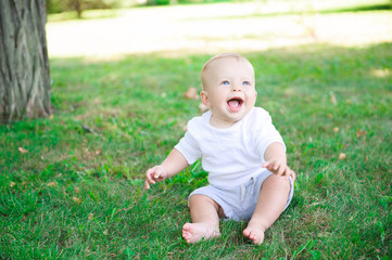 Cute cheerful child with mother play outdoors in park