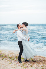 Fototapeta na wymiar same couple with a bride in a blue dress walk