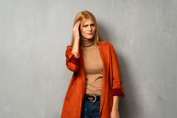 Fototapeta premium Woman over textured background unhappy and frustrated with something