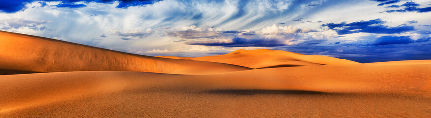 Fototapeta na wymiar Dunes Storm Wide Clouds Pan