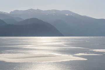 mountains lake frozen ice silver sunlight