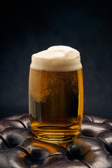 glass of beer with foam on white background
