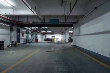 old parking lot with lighting, concrete building