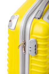 Close-up of a yellow modern travel suitcase with code zip lock