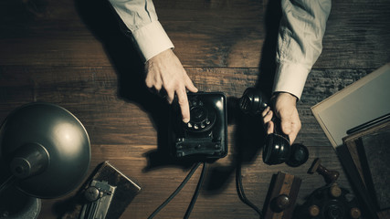 Office worker making a phone call late at night in a vintage office