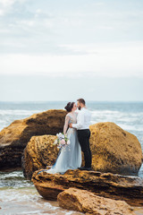 same couple with a bride in a blue dress walk