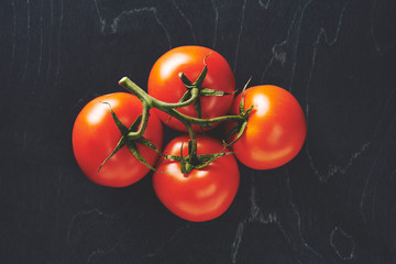 tomatoes on black background