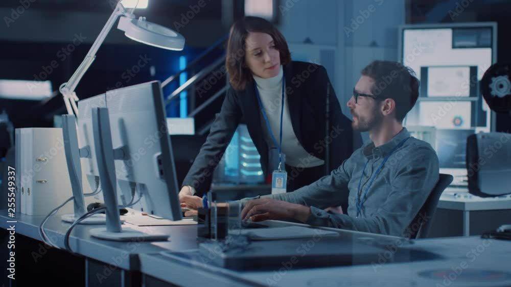 Aufkleber Futuristic Machine Engine Development Engineer Working on Computer at His Desk, Talks with Female Project Manager. Team of Professionals Working in the Modern Industrial Design Institution