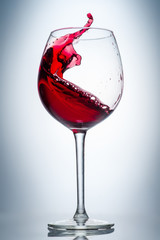 red wine pouring into a glass