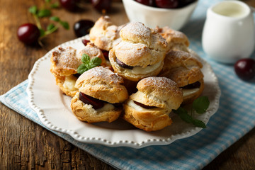 Choux pastry buns with custard and cherry