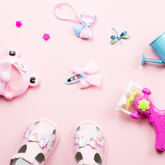 Baby girls accessories - sandals, toys. Childhood concept flat lay.