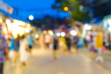 Abstract blurred people walking on market with light of bokeh