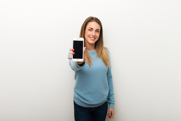 Blonde woman on isolated white background showing the mobile