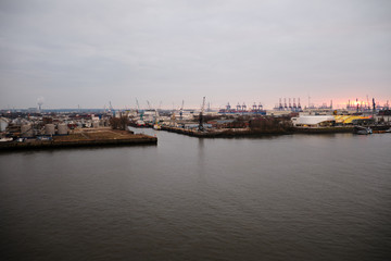Fototapeta premium Hamburg Harbor with beautiful sunset and loading cranes