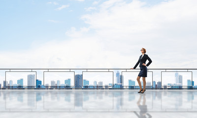 Sunrise above skyscrapers and businesswoman facing new day