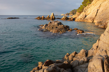 Spain, Costa Brava seascape. Sea morning landscape with cliffs and rocks in water near beach