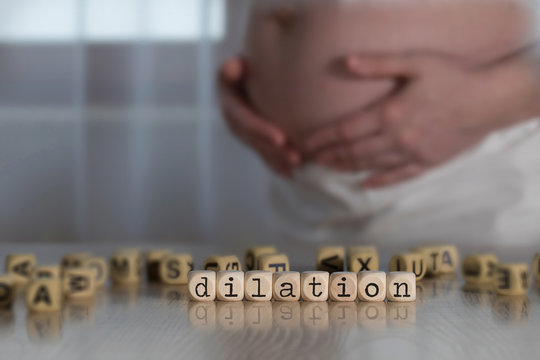 Word DILATION composed of wooden letters.