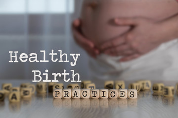 Words HEALTHY BIRTH PRACTICES composed of wooden letters.