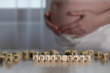 Term APGAR TEST composed of wooden letters.