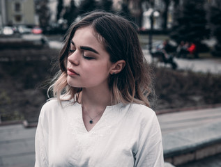 girl with blond hair sits and dreams