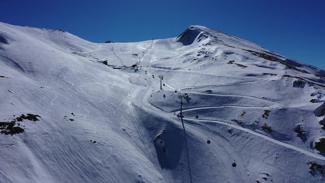 Aerial drone video of iconic snowed mountain of Parnassus with popular ski resort covered up in snow and unique nature, Voiotia, Greece