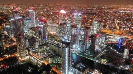 Fototapeta na wymiar Aerial drone night shot from iconic Canary Wharf skyscrapers business area, Isle of Dogs, London, United Kingdom, 
